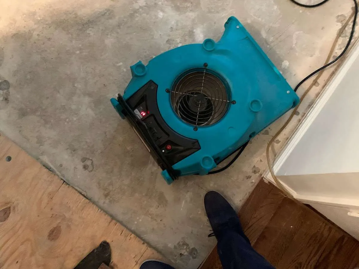 Air mover drying subfloor during Leak Detection & Repair in Canfield